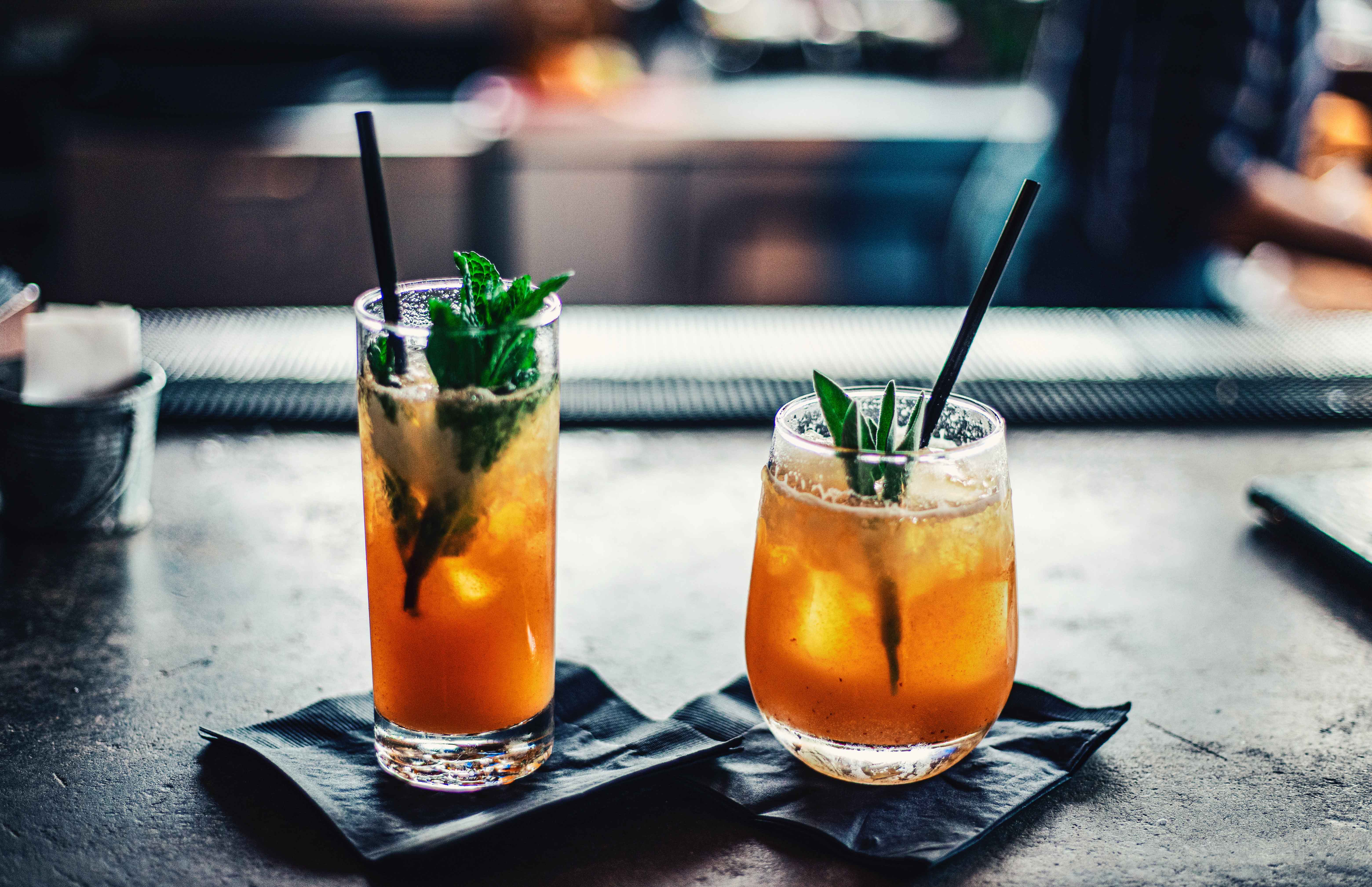 Two cocktails with a mint garnish