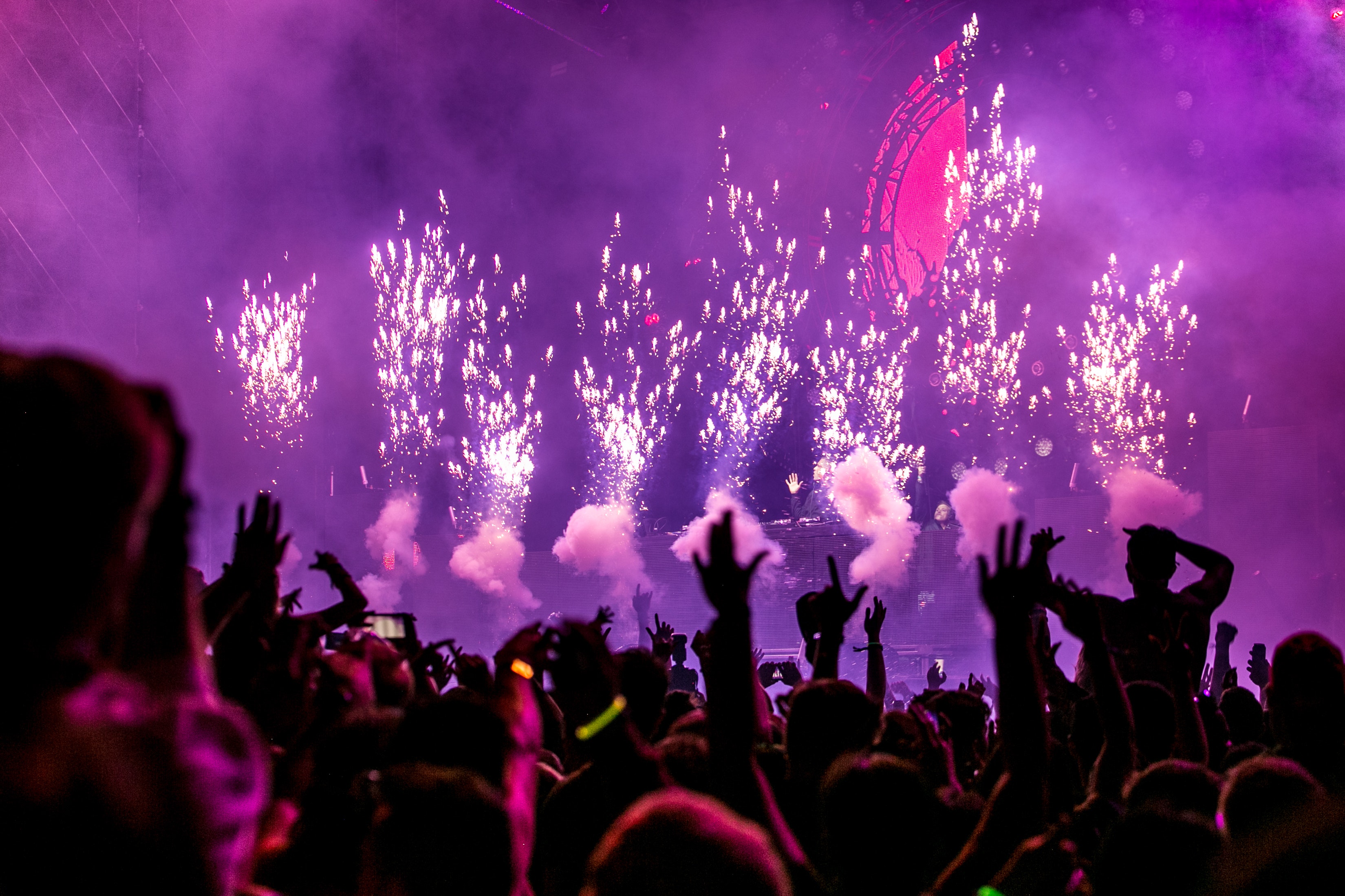 Event hall with neon lights and firework display.